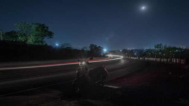 motorcycle-parked-road-night_1048944-15691835
